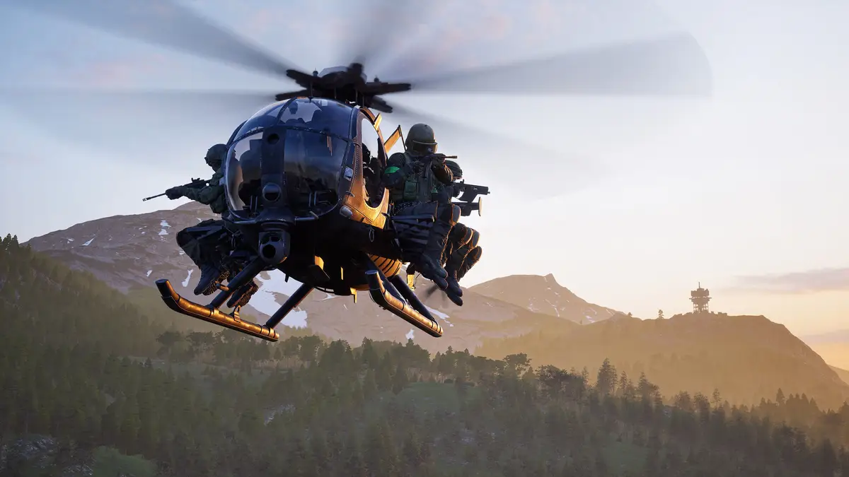 A helicopter flying low over forested hills toward a tower on a ridge